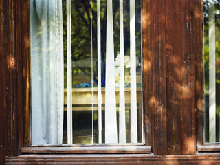 Blinds on the window of wooden house