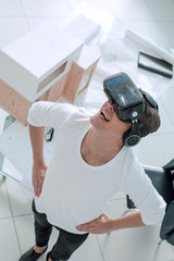 architect in a virtual reality helmet in the creative Studio