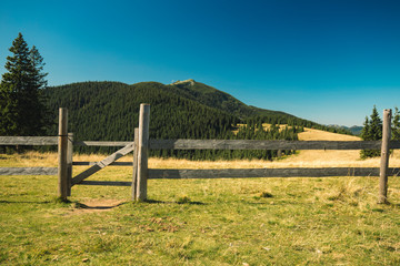 Fototapeta premium highland mountain rural scenic environment view and rural rustic wooden fence 