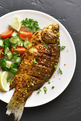 Roasted fish on plate