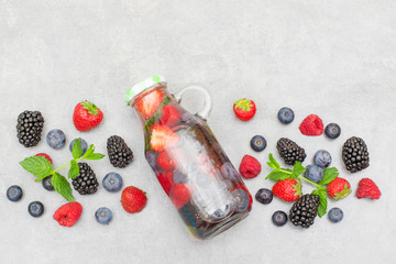 Health care, fitness, healthy nutrition diet concept. Fresh cool berry and mint infused water,  detox drink, in a glass jar.
