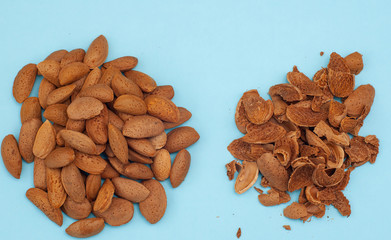 Fresh healthy tasty nutritious almond on light blue background. Top view. Flat layout. Horizontal orientation.