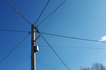 wires and pole against a blue sky