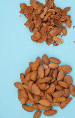 Fresh healthy tasty nutritious almond on light blue background. Top view. Flat layout. Copy space