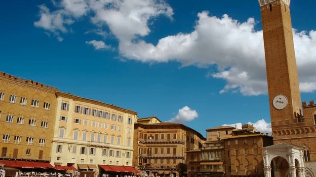 Panning shot of the Piazza del Campo and Torre del Mangia in Siena, Tuscany, Italy, a UNESCO World Heritage Site