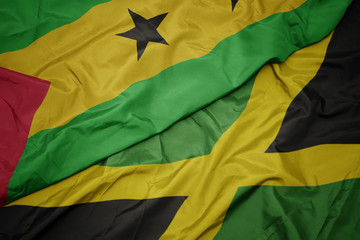 waving colorful flag of jamaica and national flag of sao tome and principe .