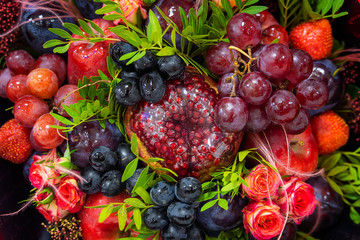 Naklejka na ściany i meble Bright beautiful stew of fruits and flowers close-up