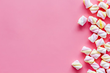 Sweets. Marshmallows frame on pink background top view space for text