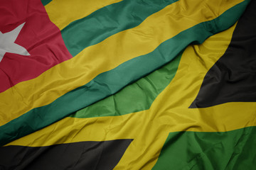 waving colorful flag of jamaica and national flag of togo.