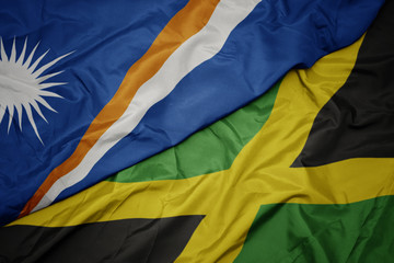 waving colorful flag of jamaica and national flag of Marshall Islands .