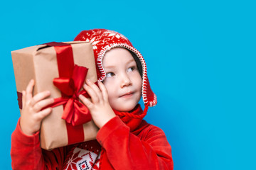 little boy holding christmas gift