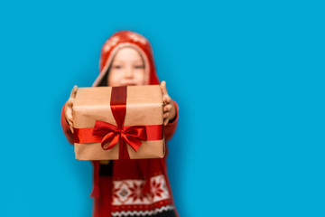 little boy holding christmas gift