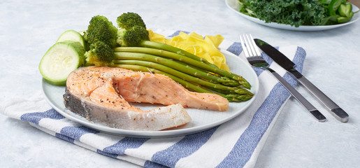 Healthy food, steamed salmon, with steamed vegetables. Eggplant, broccoli, asparagus.