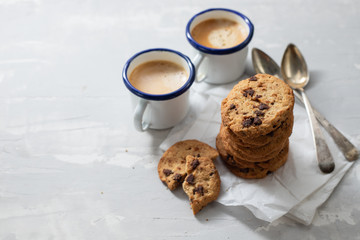 coffee and cookies with chocolate chips on ceramic background