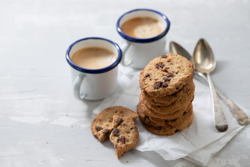 coffee and cookies with chocolate chips on ceramic background