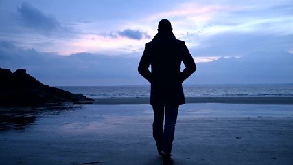 Man taking a walk at beach - Powered by Adobe