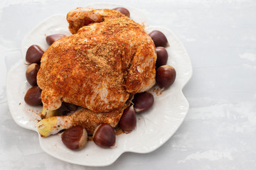 raw chicken with chestnut on white dish