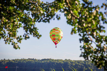 Fototapeta premium Balloon flight. Colorful balloon at the blue sky.