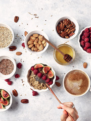 Healthy breakfast, oatmeal with raspberries, figs and nuts and seeds. The concept of a healthy lifestyle, diet. Top view