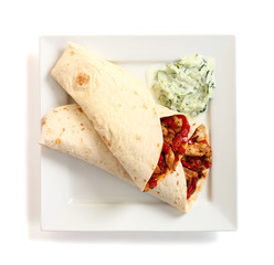 Tortilla with chicken, bell pepper and tzatziki. Isolated with c