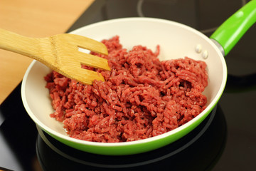 Adding ground beef into frying pan