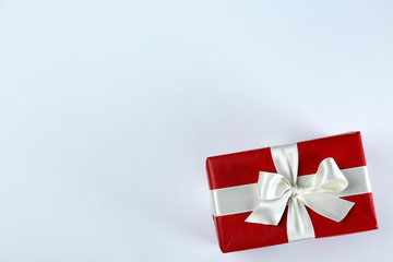 Bunch of christmas presents wrapped in red and white paper tied with shiny silk bow. Multiple new years gifts in red and white wrapping. Top view, close up, copy space, background, flat lay.