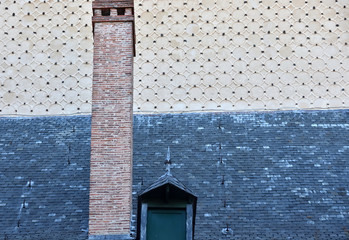 composition with chimney, roof and facade of historical building