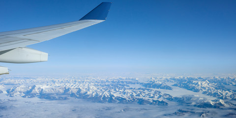 Naklejka na ściany i meble Aerial panoramic view during the fly from Amsterdam to Portland in Oregon above Greenland.