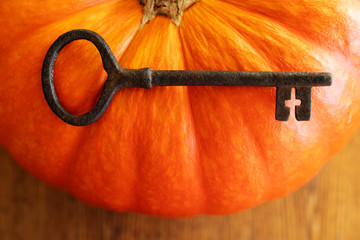 The key to traditions and family values. Huge pumpkin and rustic key with the cross inside. Fall decorations.