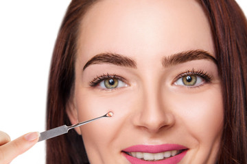 Mechanical cleaning of young female face with acne loop