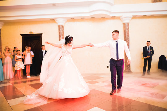 Beautiful wedding couple just married and dancing their first dance