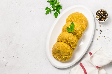 fresh turkey rissoles on white plate with parsley. Top view, copy space.