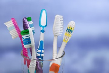 New Colorful Toothbrushes in A Glass  on  Background