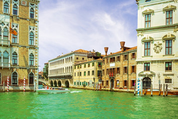 picturesque view at a venetian chanel with boat , berth and old nice palaces on the background , landscape of Venice