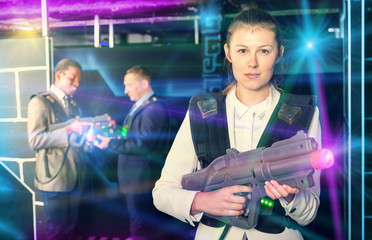 Woman holding laser gun and playing laser tag