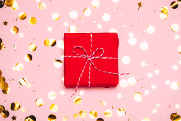 Fototapeta premium Christmas background with purple balls and present gift box and decoration on pink background.