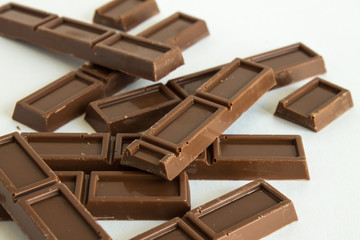 Broken chocolate bar on white background