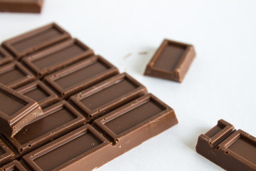 Broken chocolate bar on white background