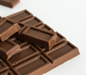 Broken chocolate bar on white background