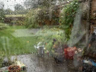 Autumn garden seen through rain splattered window