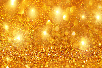 Fototapeta na wymiar Golden bokeh and shiny stars holiday background.