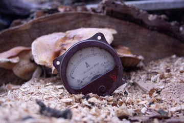 Close up of analog ammeter on the wood background