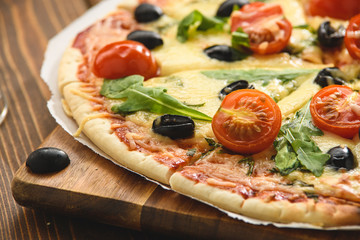 Pizza with wine tomatoes cheese and arugula