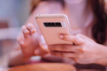 A young woman using an smartphone indoor