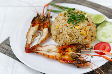 Grilled prawn and Fried rice with eggs on white plate