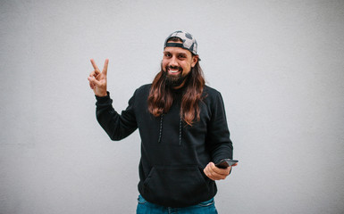 Happy hipster man celebrates victory after winning at an online bookmaker or casino. Crazy emotions. Jackpot