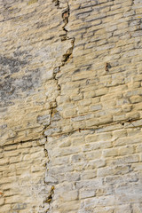 Old brick wall with big crack