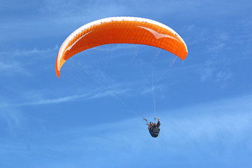 Paraglider flying wing in a blue sky	