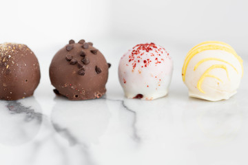 Assorted truffles on white marble background