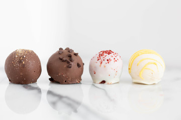 Assorted truffles on white marble background